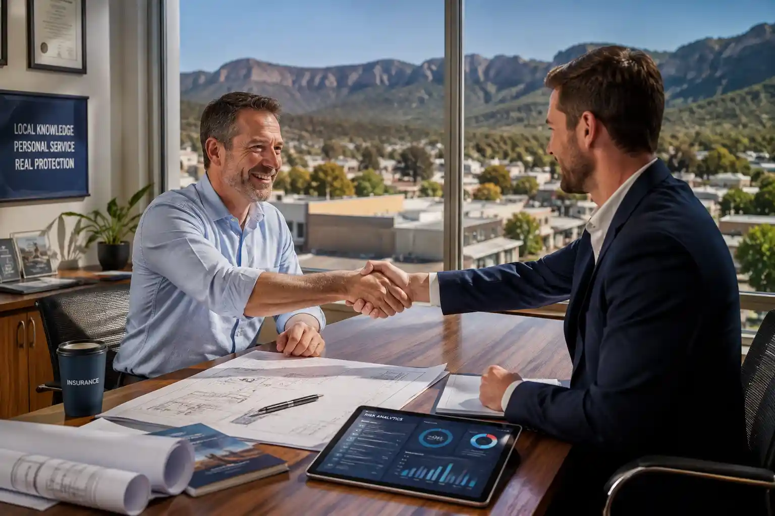 Business insurance Stawell showing commercial business owners reviewing risk management and insurance policies with a financial adviser