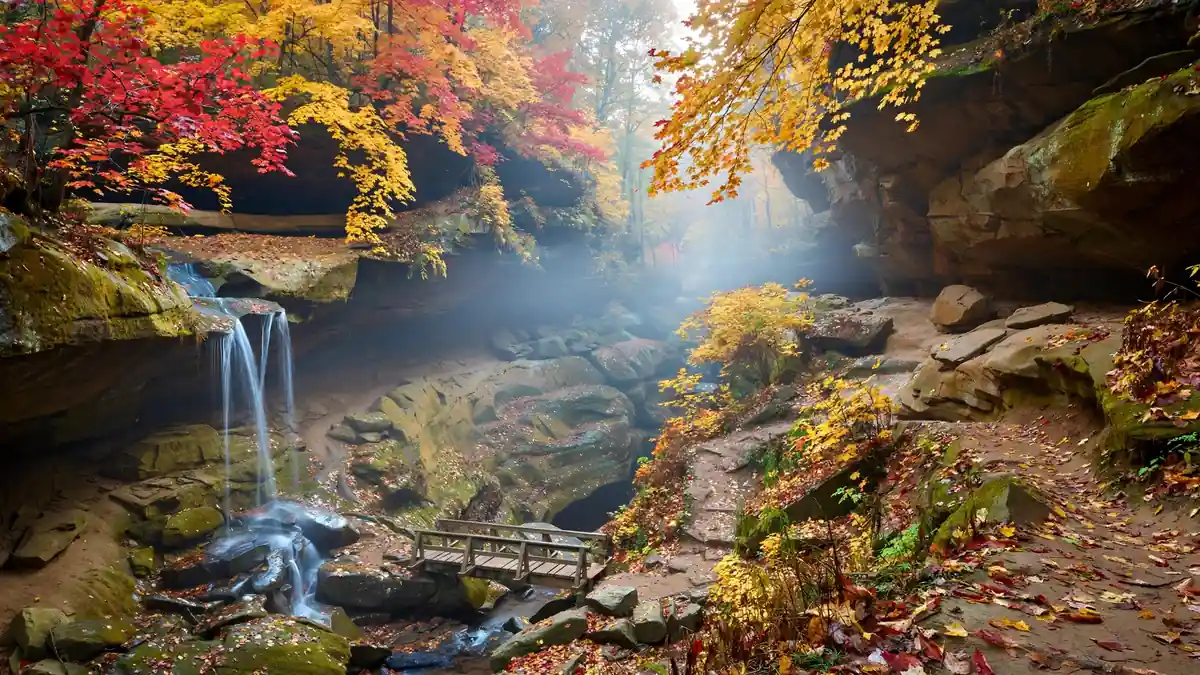 Fall foliage over a sandstone gorge and waterfall in Ohio