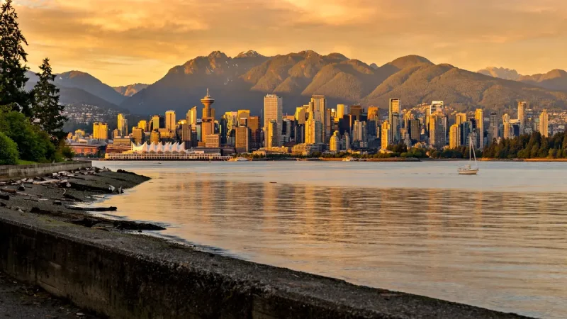 Vancouver British Columbia skyline and harbour with North Shore mountains at sunset