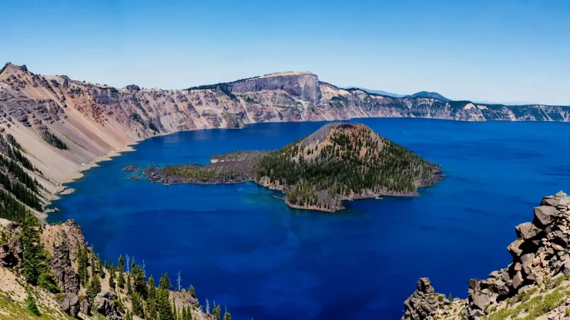 Deep blue water and volcanic cliffs at Crater Lake, a contender for the best place to visit in Oregon