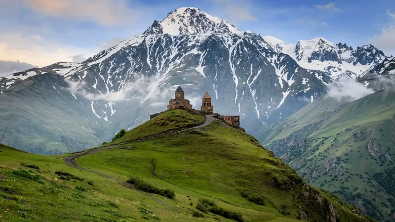 Gergeti Trinity Church beneath snowy Mount Kazbek, one of the most unique places to visit in Georgia country